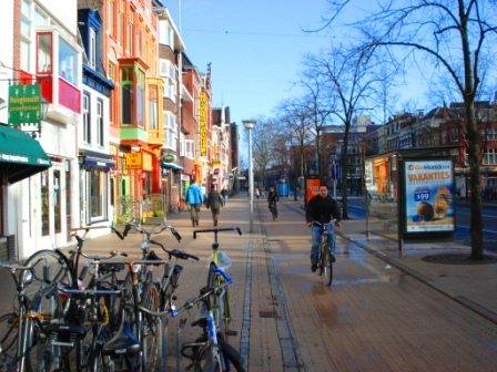 Bike path next to sidewalk and separated from road by a median in the city center of Groningen, Netherlands. Image Credit: Zachary Shahan / Bikocity
